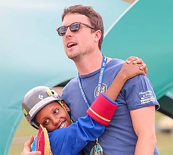 Child with mentor at camp