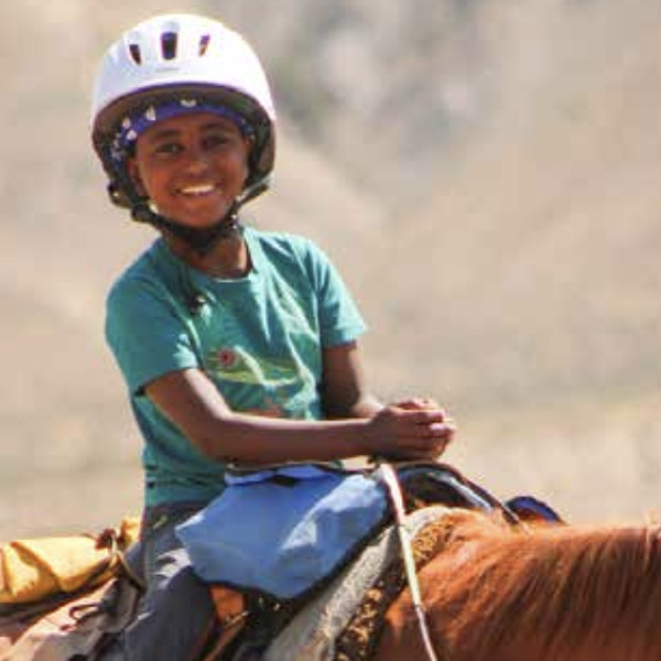 Kid enjoing horseback ride