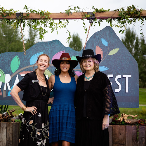 A grateful harvest attendees in front of sign