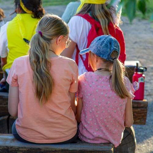 Campers sitting together on a bench
