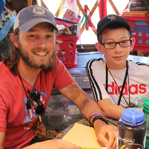 Camp counselor and camper in art yurt