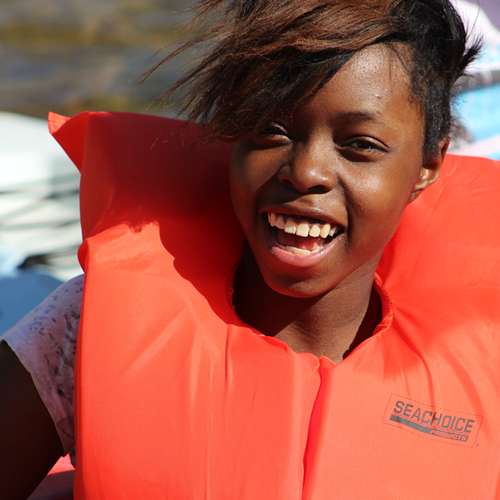 Camper in lifevest canoeing