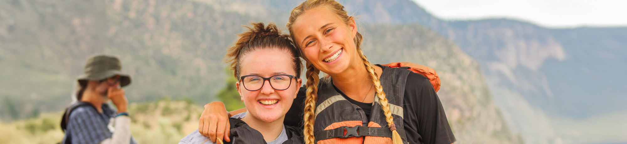 howdy hangout camper and counselor smiling at the camper before rafting