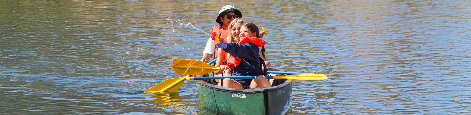 campers in canoe shooting squirt gun