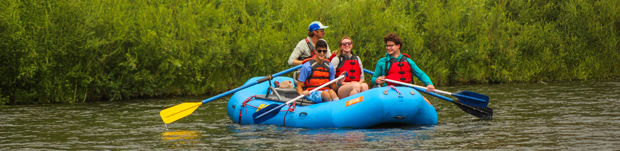 Spur program campers on the river in a raft.